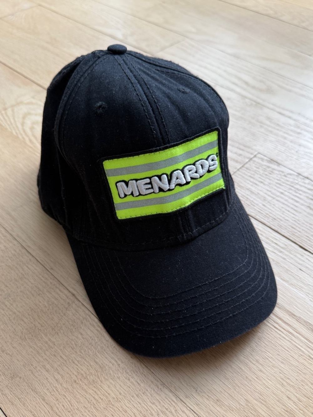 Menards Black Baseball Cap with Neon Green Patch